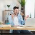 Man in headset having video conference on modern laptop